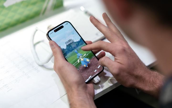 A contestant plays Pokémon Go during the 2023 Pokémon World Championships in Japan on August 11.  The app, which launched in 2016, allows users to navigate the physical world to discover and catch different types of fictional creatures.