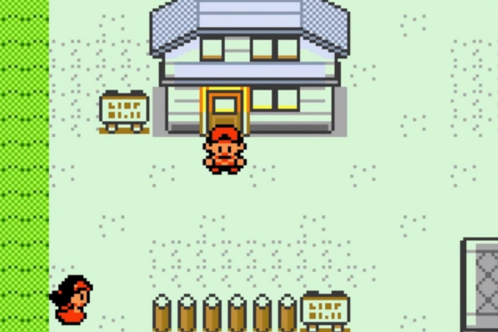 A player in front of a building in Pokemon Gold