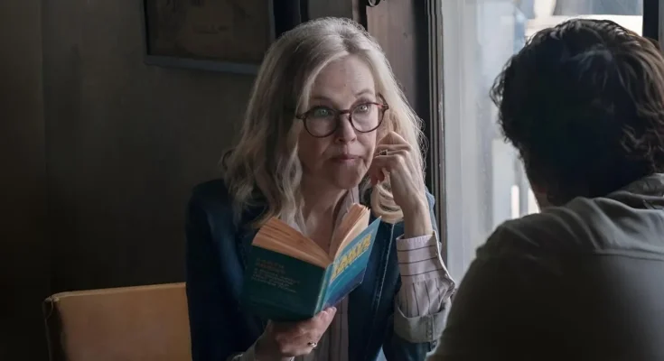 Catherine O'Hara smiling on the red carpet at the Emmy Awards, wearing a glamorous gown, representing her role as comedy legend Moira Rose.