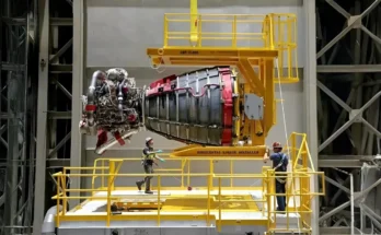 The base of the SLS rocket showing the four RS-25 engines, heavily frosted with ice, sitting on the mobile launcher at Kennedy Space Center.